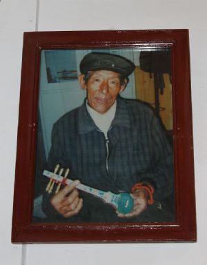 Tibetan artisan holding a model danyen