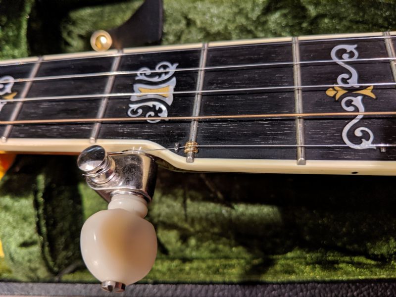 Any easy way to raise action on the 5th string when banjo has no pip